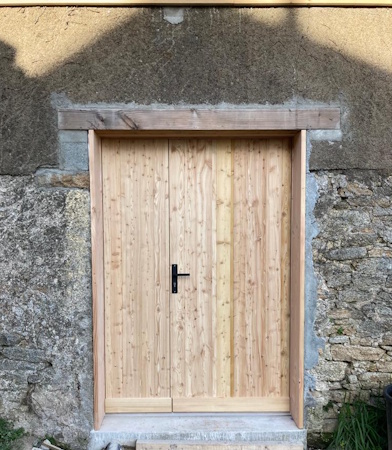 Porte double en bois dans mur en pierre